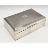 A hallmarked silver cigarette box with Greek key design to rim