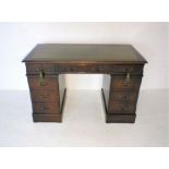 A reproduction mahogany kneehole desk, with green leather inset top, length 121cm, depth 61cm,