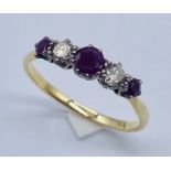 A diamond and garnet five stone ring set in unmarked gold (tested 14ct)