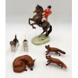 A Beswick Huntsman on rearing bay horse (868) along with two Beswick hounds and three Beswick foxes