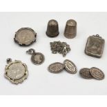 A hallmarked silver locket, silver cufflinks, thimbles etc.