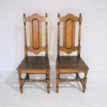 A pair of oak hall chairs, with pegged joints.