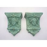 Two green glazed terracotta wall mounted garden planters.