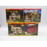 A collection of four boxed Hornby Skaledale OO gauge scale model buildings including Bramble Cottage