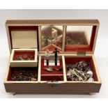 A collection of costume jewellery in a musical jewellery box