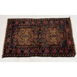An Eastern red ground rug with geometric design 80cm x 132cm