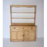 An antique pine dresser, open top with seven small drawers, length 159cm, depth 45cm, height 218cm.