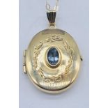 A 9ct gold locket set with a topaz on fine gold chain, total weight 2.4g