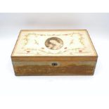 An antique sewing box with embroidered top, containing a quantity of lace and fabrics etc, A/F.