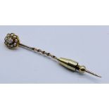 An unmarked gold (tested 9ct) tie pin set with seed pearls and a mine cut diamond- diamond