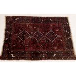 A small Eastern red ground rug 120cm x 84cm