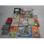 A collection of vintage games and jigsaw puzzles including Halma, Pit, Animal Sixes, Othello etc