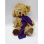A 1950's Merry Thought "Cheeky" bear in golden mohair plush with original scarf, amber eyes, bells