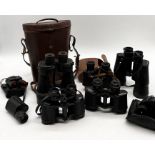 A collection of vintage binoculars including a pair of Ross London "Stepnite" 7 x 50
