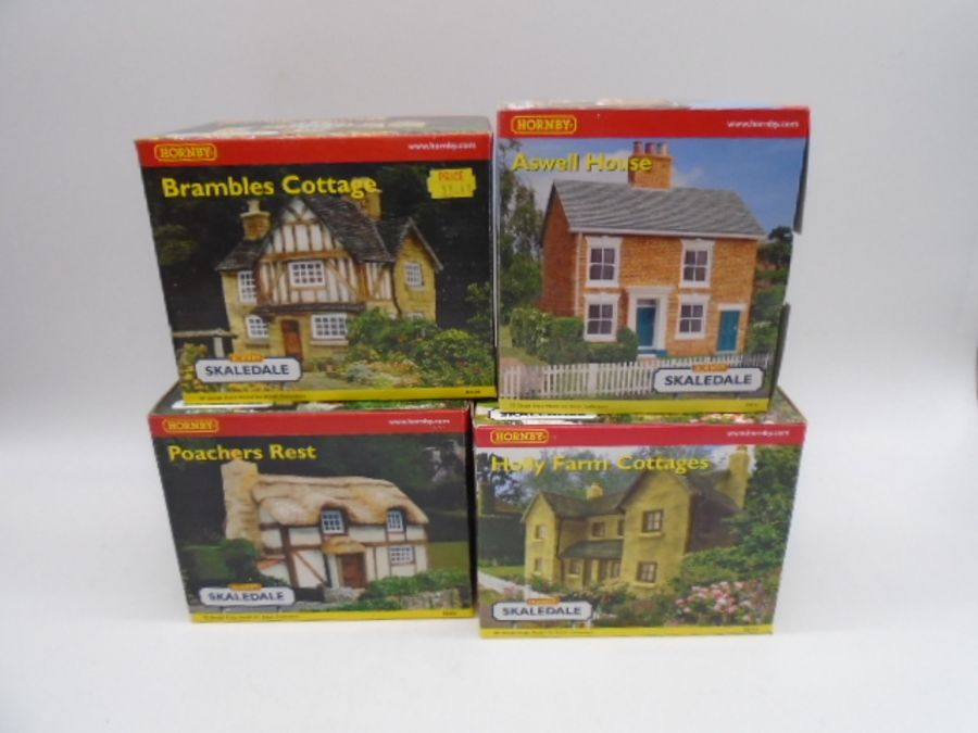 A collection of four boxed Hornby Skaledale OO gauge scale model buildings including Bramble Cottage