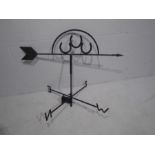 A vintage wrought iron weather vane with three horseshoes