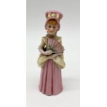 A Royal Worcester candle snuffer 'Town Girl', modelled as a young girl in pastel colouring with gilt