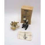 A boxed Merit Student's Microscope, along with a miniature sextant.