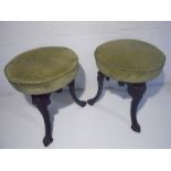 A pair of late nineteenth century cast iron stools with green upholstered seats.