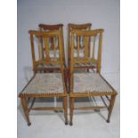 A set of four oak Art Nouveau dining chairs.