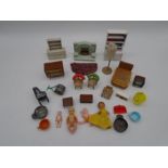 A small collection of doll's house furniture including a fireplace, rug, chest of drawers, bed,