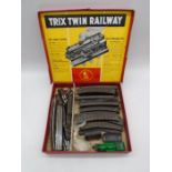 A Dublo Meccano OO gauge locomotive with two wagons, along with a selection of Trix Twin Railway