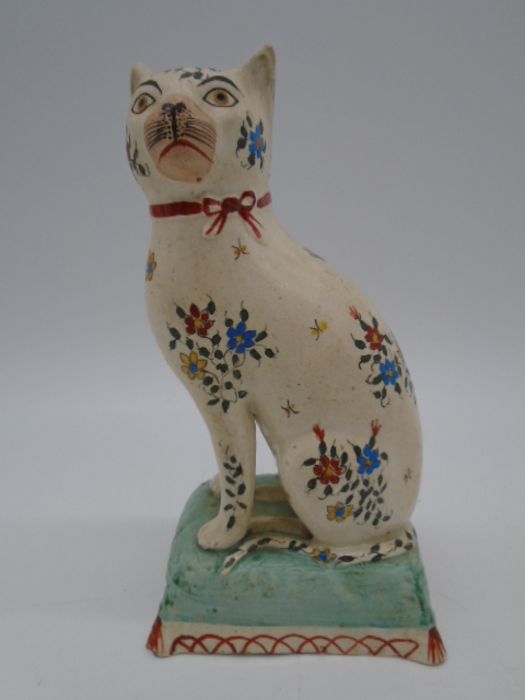 A 19th Century Staffordshire figure of a seated cat on a cushion, height 18.5cm