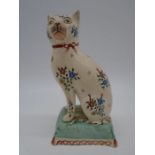 A 19th Century Staffordshire figure of a seated cat on a cushion, height 18.5cm
