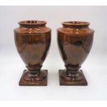 A pair of "What's Vincent Cadeaux" brown glazed vases, height 32cm.