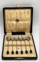 A cased set of silver plated coffee bean spoons