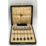 A cased set of silver plated coffee bean spoons