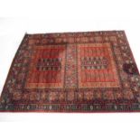 An eastern style red ground rug 232cm x 170cm (in need of cleaning).