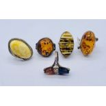 Five 925 silver rings set with amber