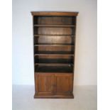 A hardwood bookcase with cupboard under, length 90cm, height 183cm.