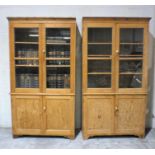 A matched pair of pitch pine display cabinets, with cupboards under, length 109cm, height 203cm