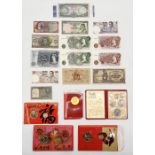 A collection of various banknotes and Singapore Mint coin sets including 10 shillings, £5, £1