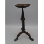 A wrought iron candlestick on tripod legs, height 45cm