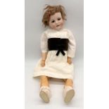 A Max Handwerk Bebe Elite bisque headed fully jointed doll with open mouth and sleeping eyes