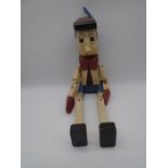 A handcrafted wooden Pinocchio with jointed limbs