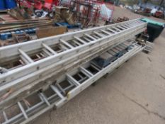 STACK OF ASSORTED LADDERS/LADDER SECTIONS, INCLUDING LARGE TRIPLE STAGE ALI LADDER.