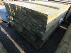 LARGE PACK OF PRESSURE TREATED FEATHER EDGE CLADDING TIMBER. LENGTH 1.35M X 100MM WIDTH APPROX.