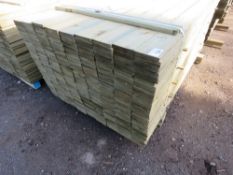 LARGE PACK OF PRESSURE TREATED FEATHER EDGE CLADDING TIMBER. LENGTH 1.8M X 100MM WIDTH APPROX.