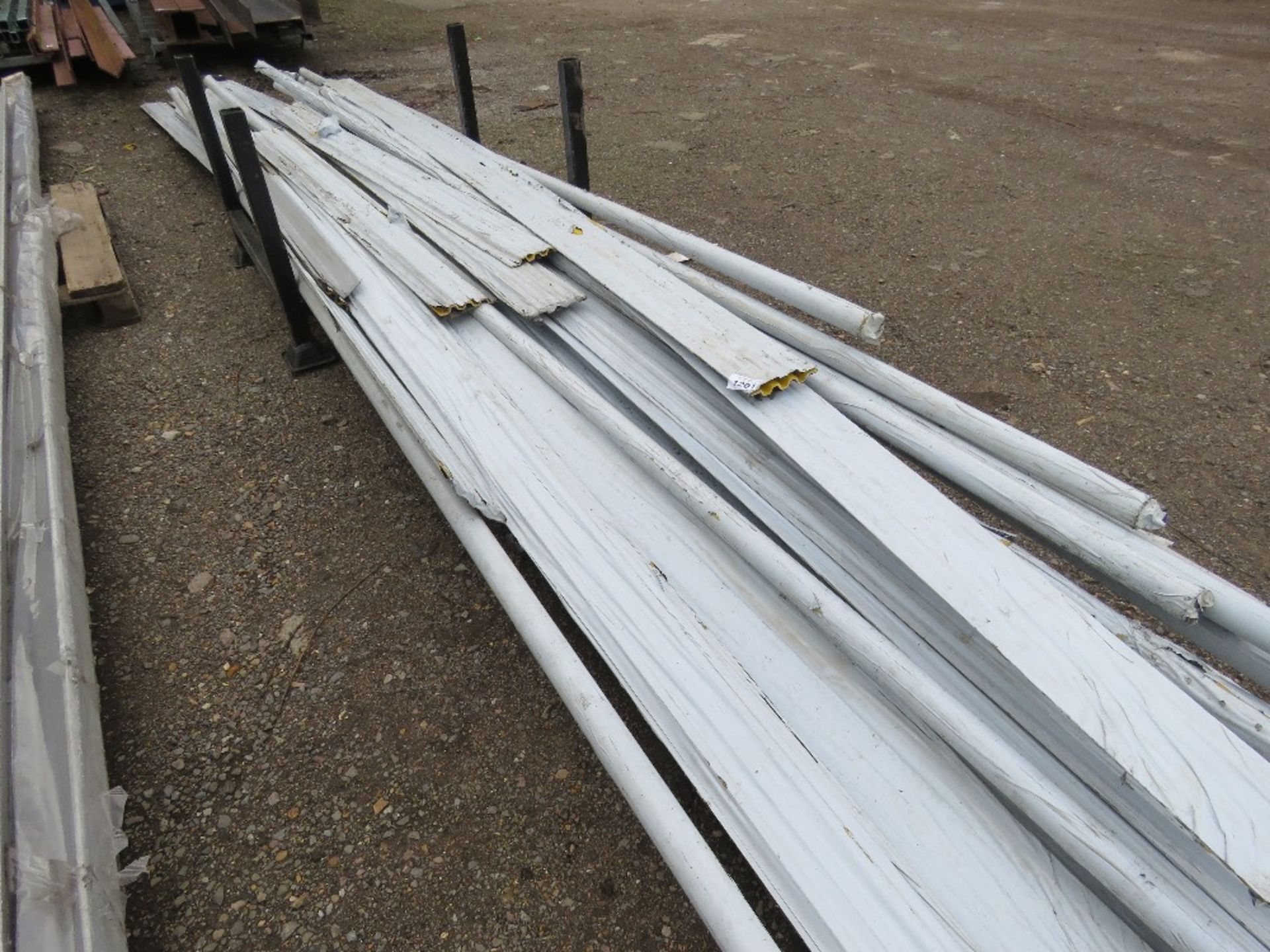 STILLAGE CONTAINING ASSORTED YELLOW PLASTIC CLADDING, 4FT - 20FT LENGTH APPROX. THIS LOT IS SOLD UND