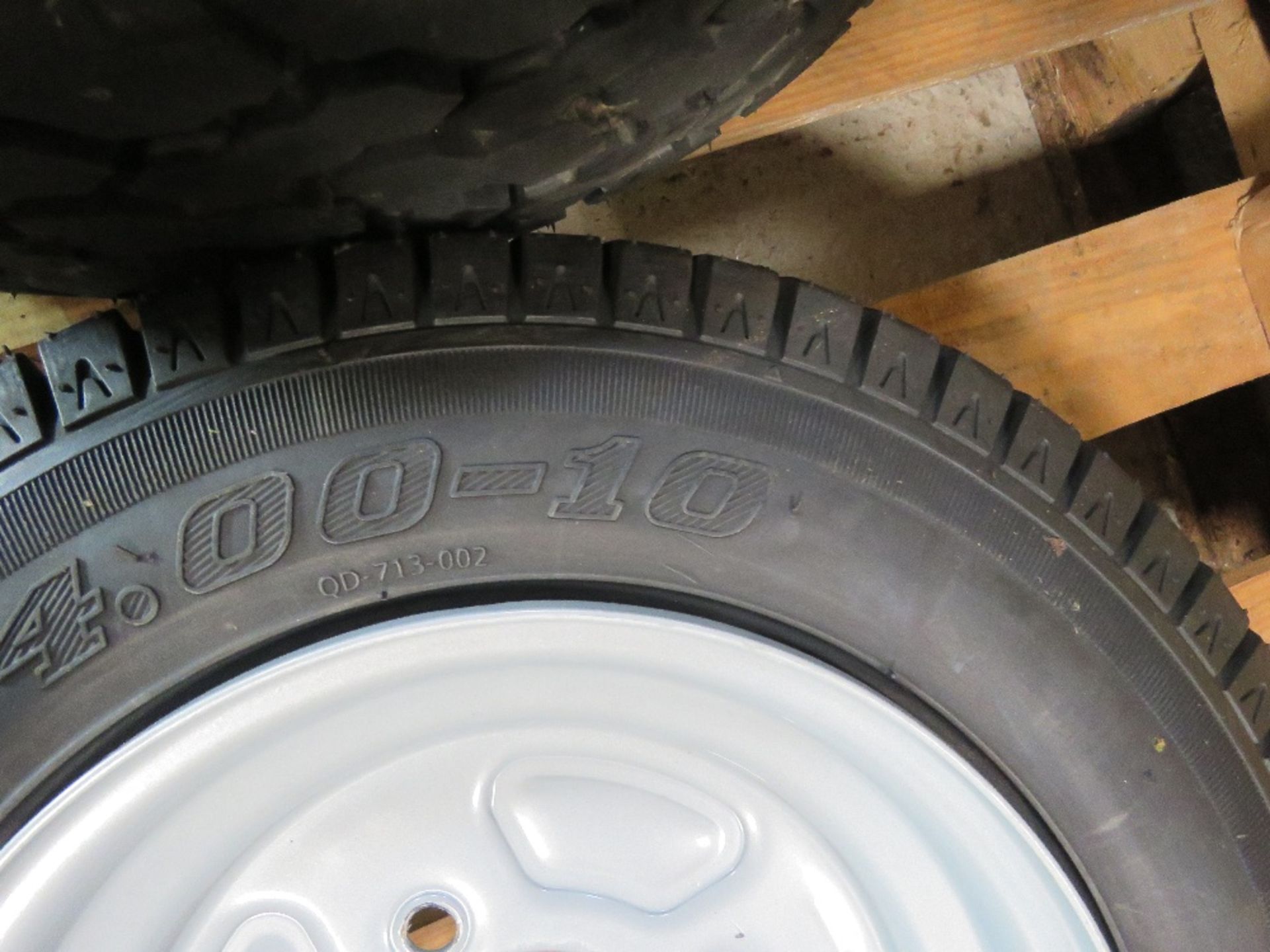 SMALL TRAILER WHEEL, 4 STUD RIM 4.00-10, UNUSED. - Image 2 of 2