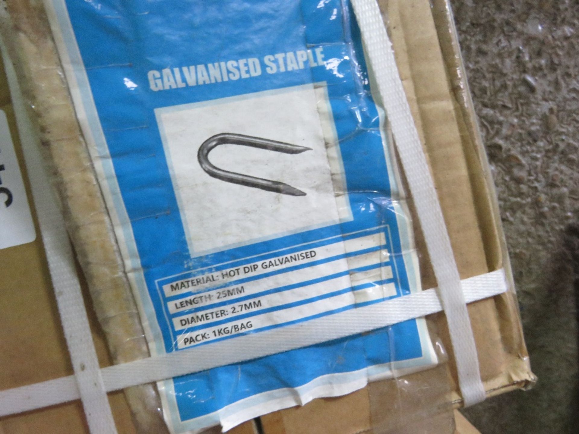 BOX CONTAINING 25KG OF 25MM X 2.7MM GALVANISED FENCING STAPLES.