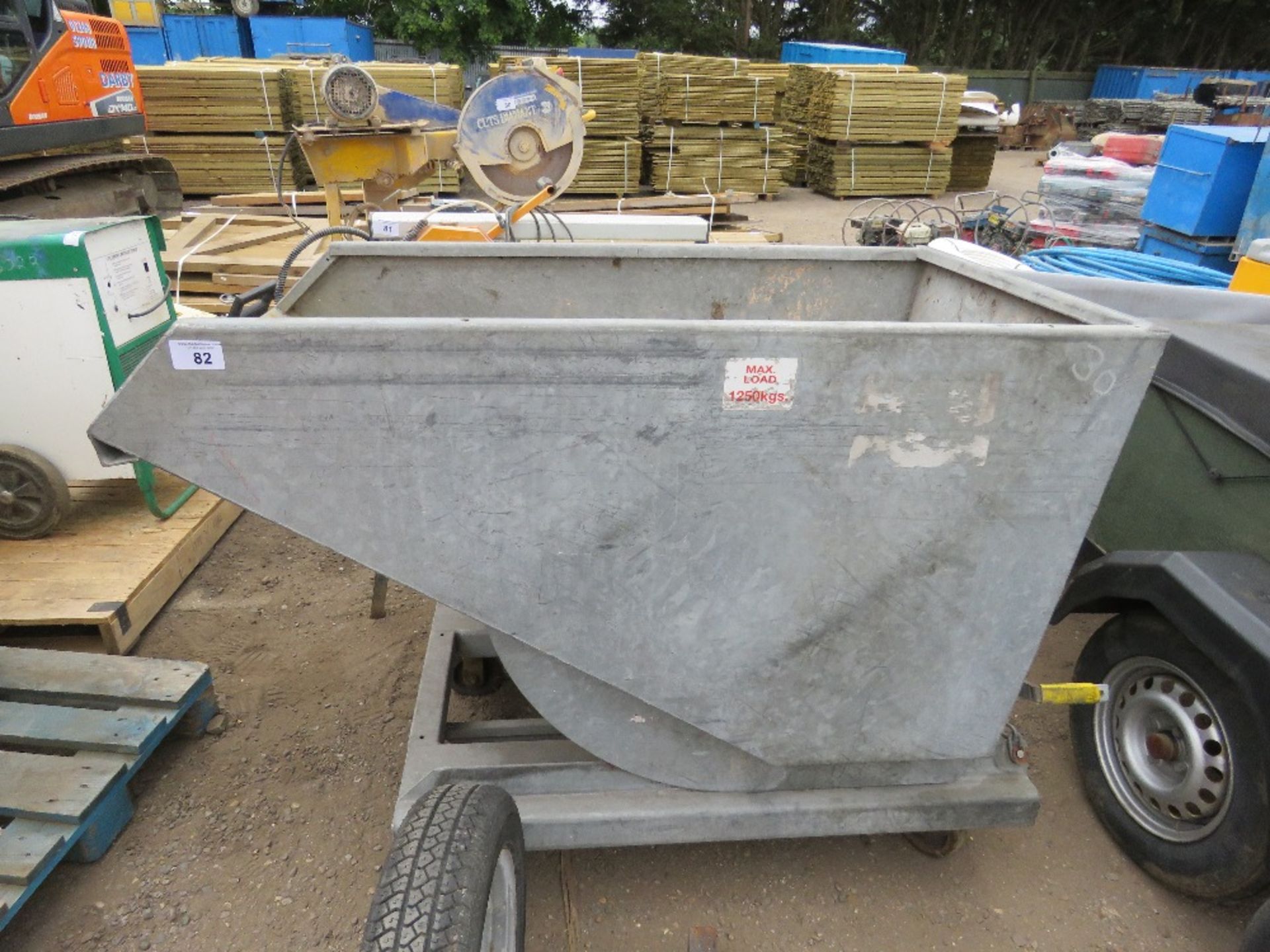 FORKLIFT MOUNTED TIPPING SKIP ON WHEELS.