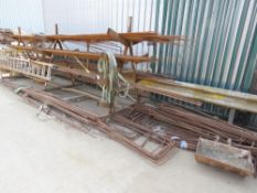 LARGE QUANTITY OF ASSORTED REBAR ON A RACK PLUS SOME PRE BENT ON THE FLOOR, AS SHOWN. INCLUDES THE