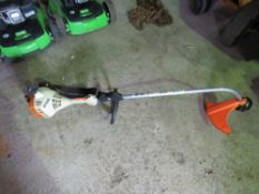 STIHL PETROL STRIMMER WITH A HARNESS. THIS LOT IS SOLD UNDER THE AUCTIONEERS MARGIN SCHEME, THERE