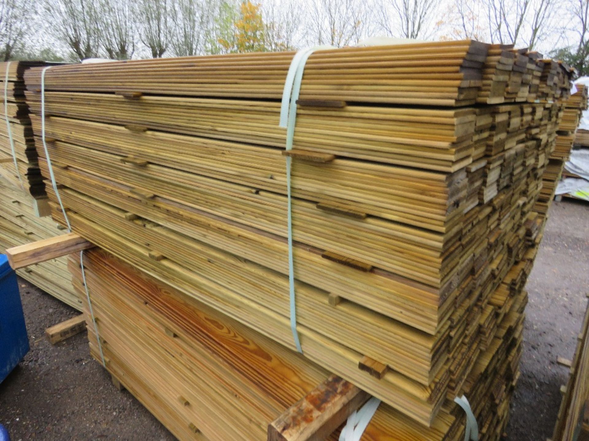 LARGE PACK OF TREATED HIT AND MISS TIMBER CLADDING BOARDS. 1.75M LENGTH X 95MM WIDTH APPROX.