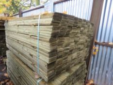 STACK OF TREATED FEATHER EDGE TIMBER: 2 X LARGE PACKS @ 1.8M LENGTH 100MM WIDTH APPROX.